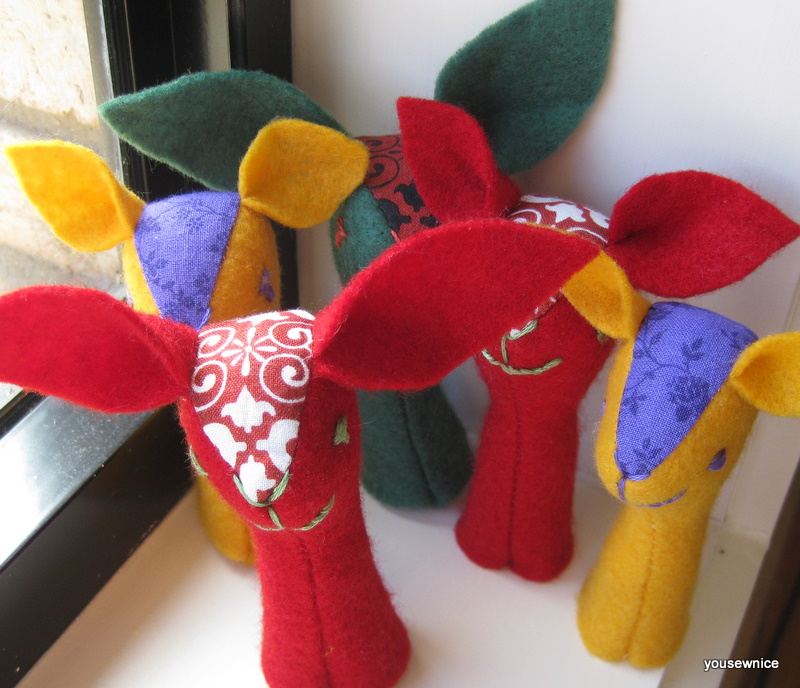 a group of five brightly colored finger puppets
