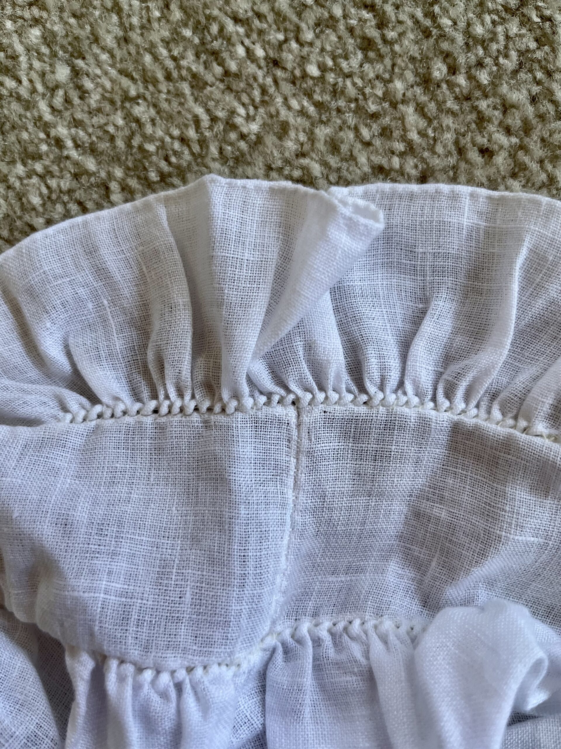 A close-up view of the band of a lappet cap - the ruffle and the caul have been gathered to fit the band.