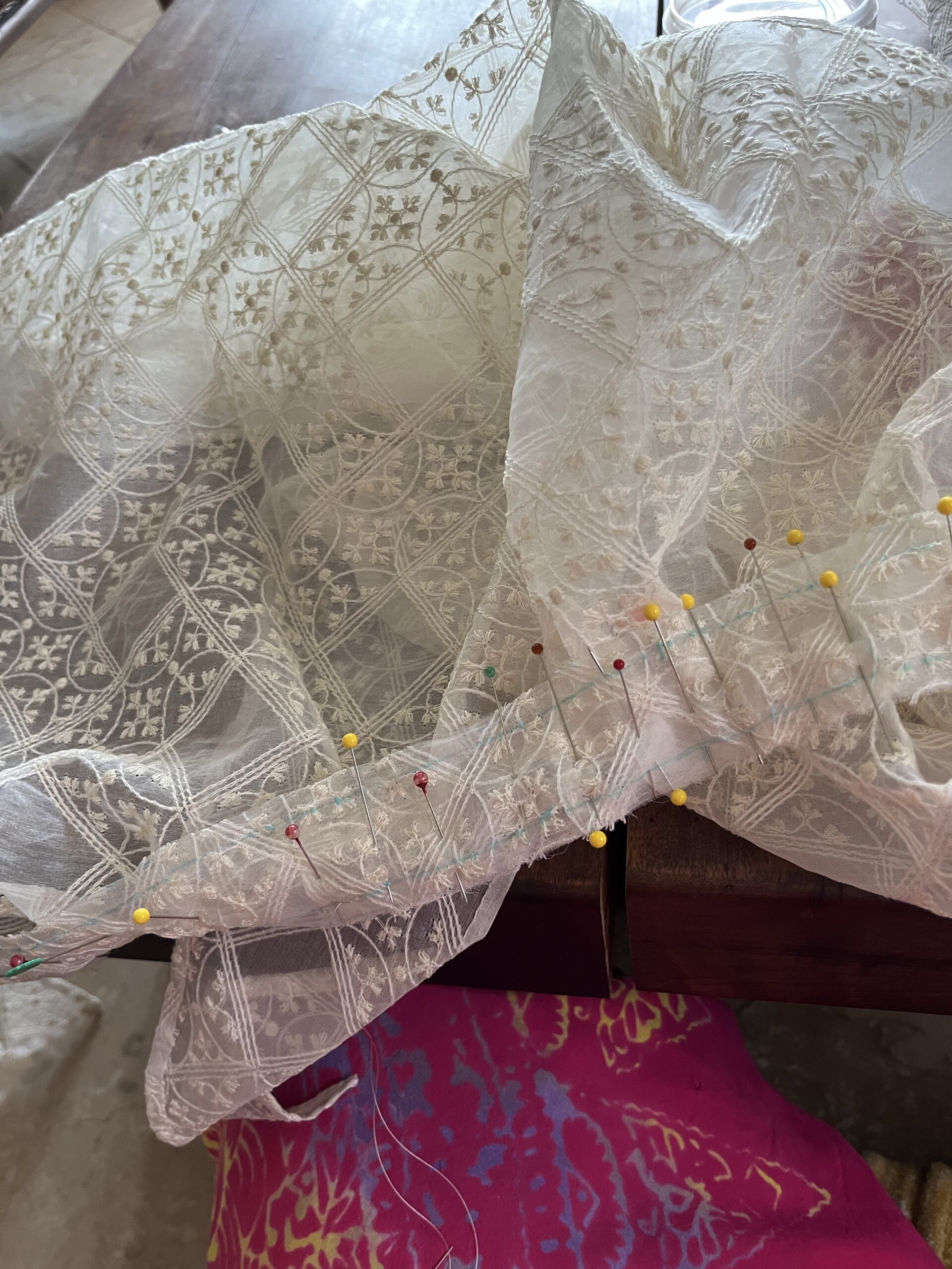 a straight neckband is being pleated to a sik gauze mantelet