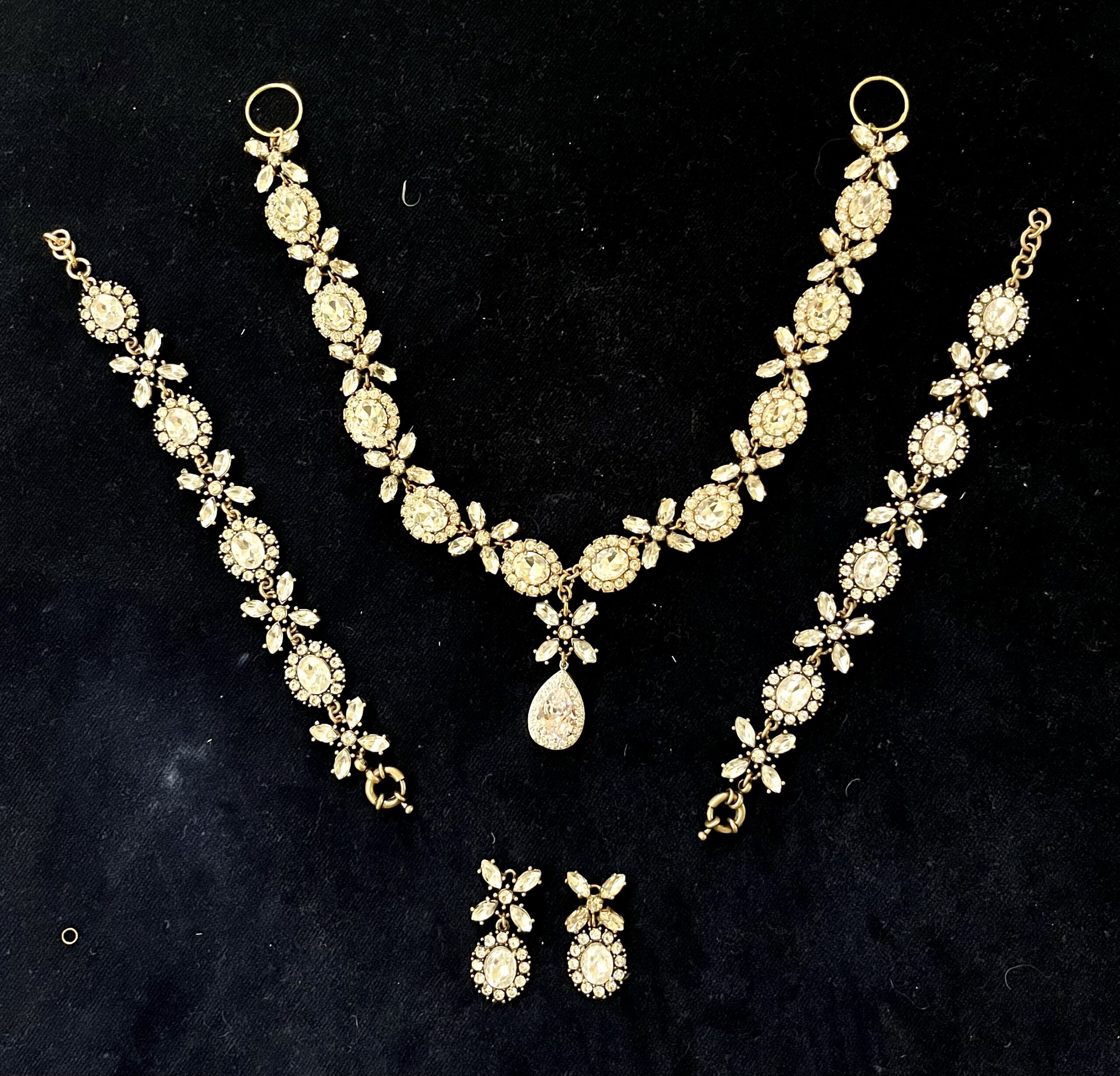 a DIY georgian parure made up of necklace, bracelet and earrings lies on a bed of blue velvet