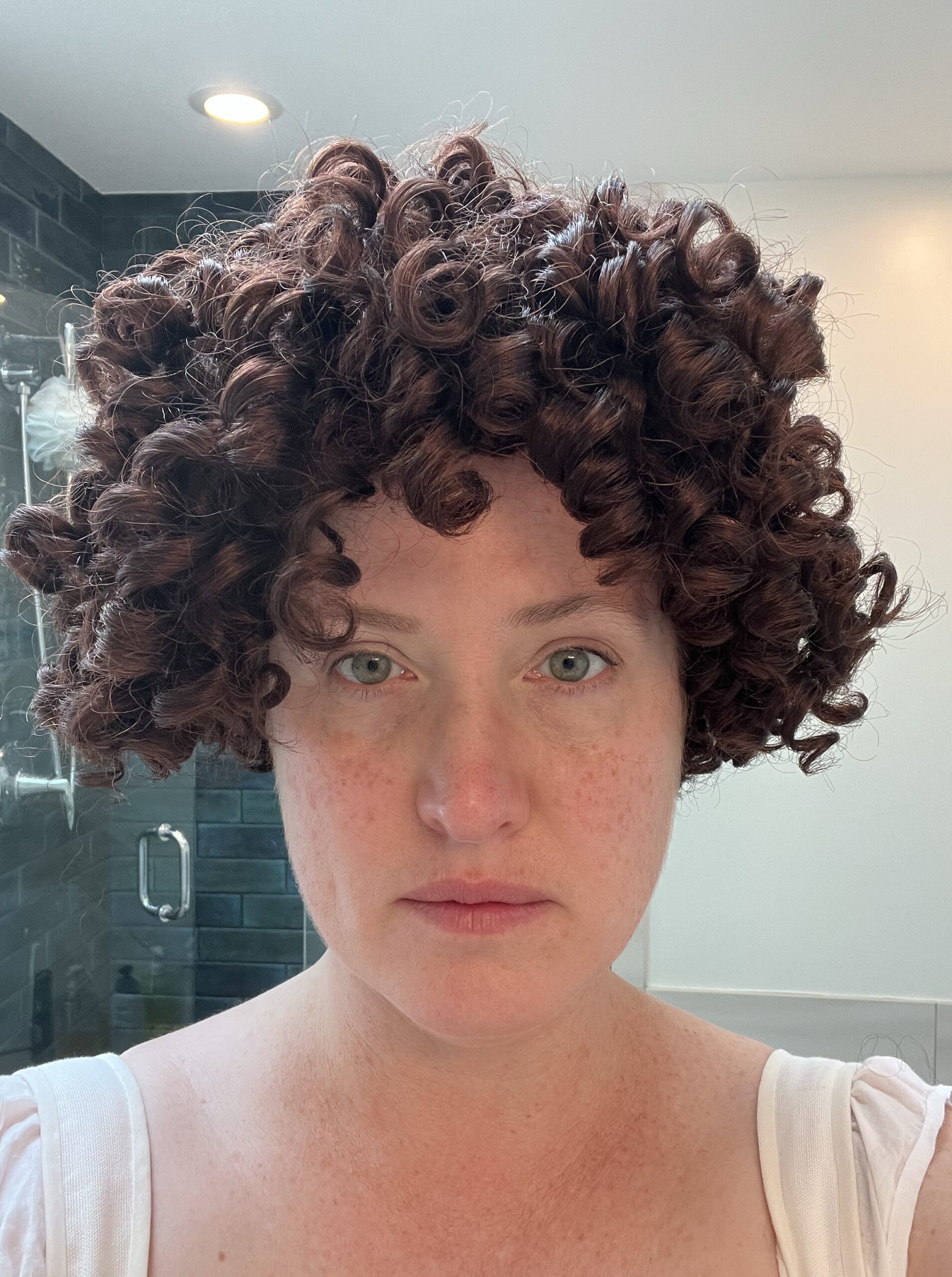 head shot of a woman with her hair styled in greco-roman ringlets
