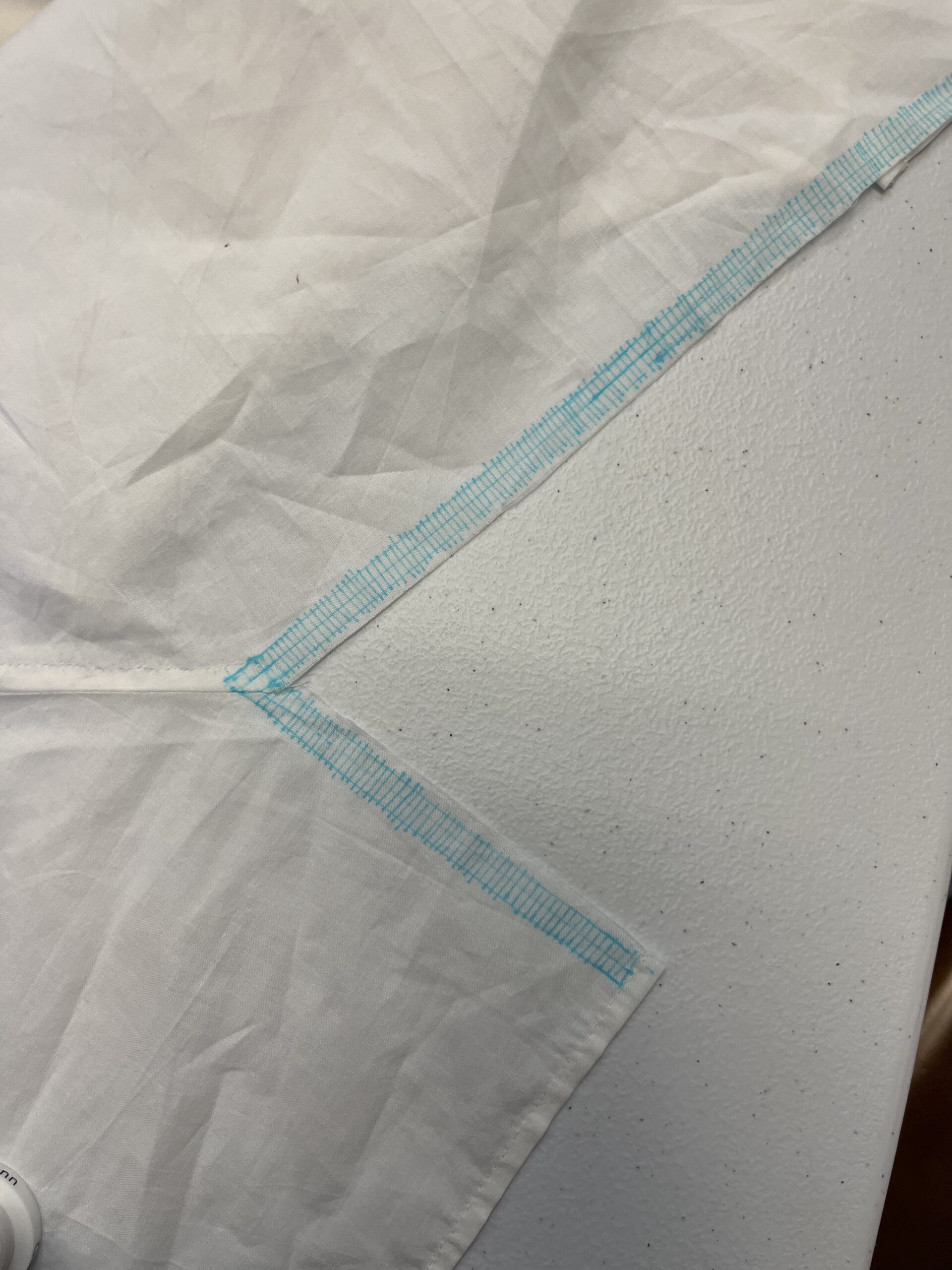 A grid of blue lines is drawn along the neckline of a regency chemisette