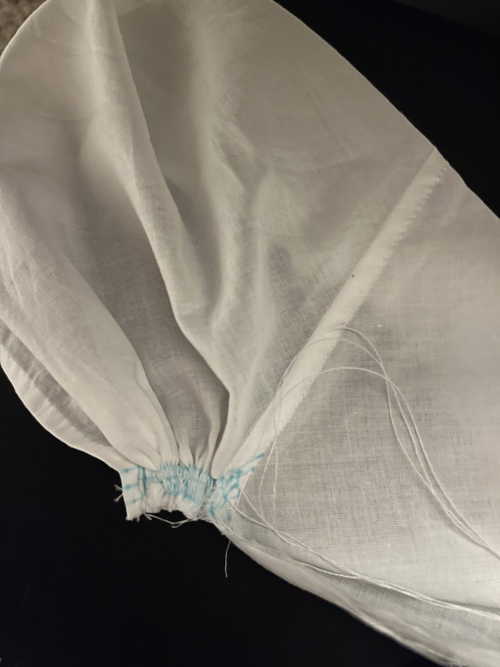 Stroked gathers are drawn tight on a 1790s chemisette