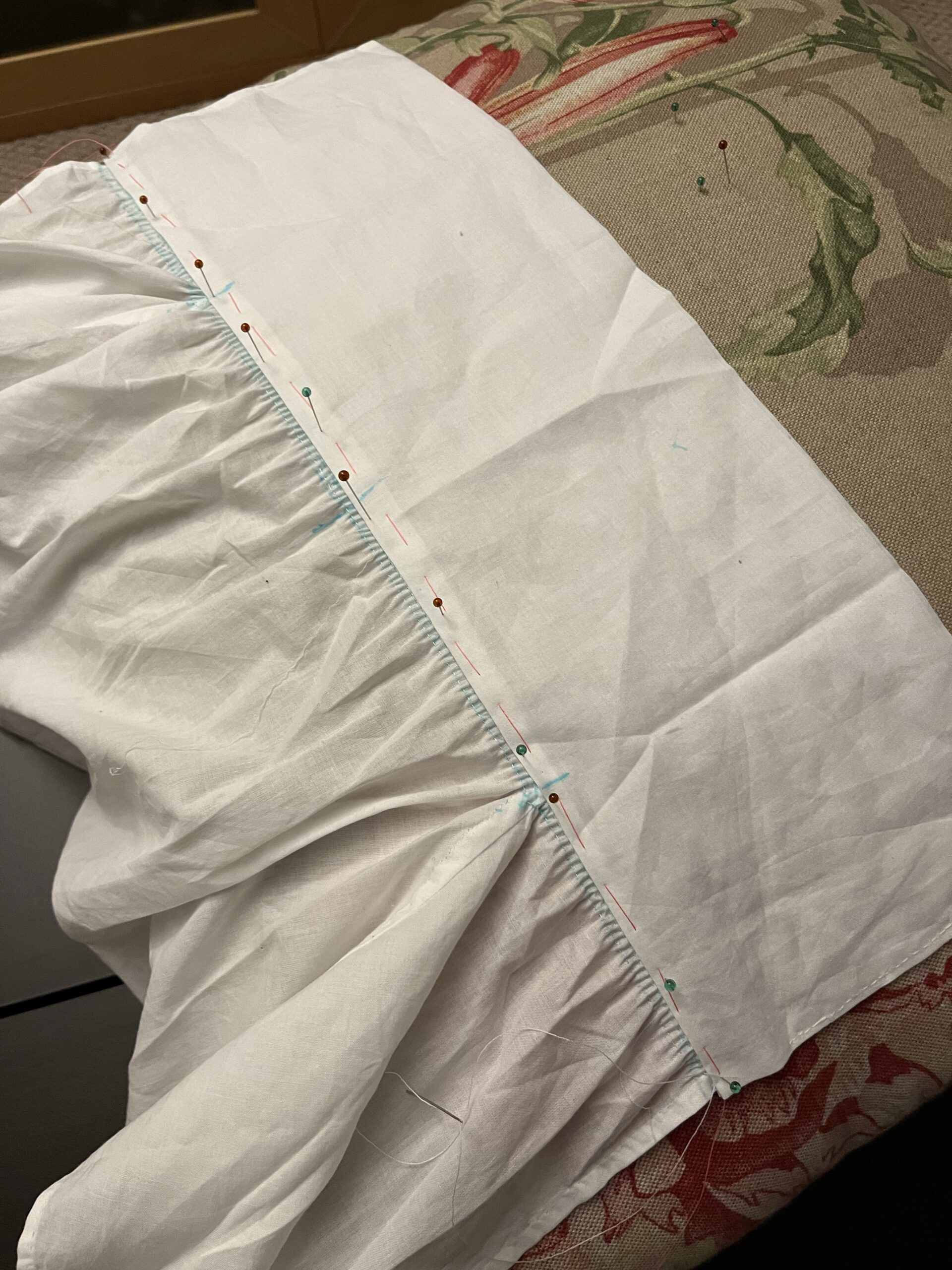 A line of beautiful stroked gathers pinned to the neckline of a 1790s chemisette