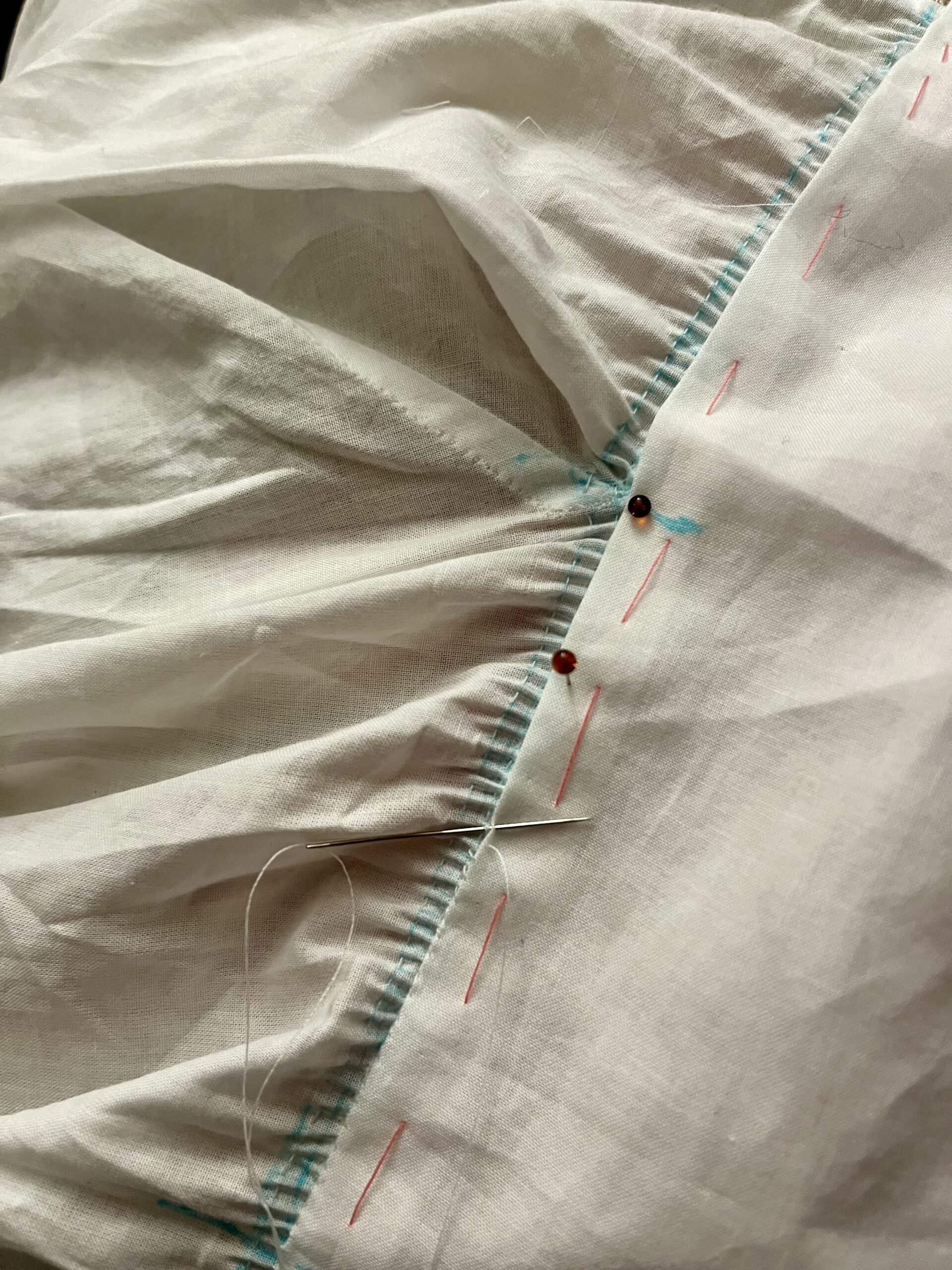 The neckline of a chemisette is pinned to the collar. The corners are tricky and need to be fudged.