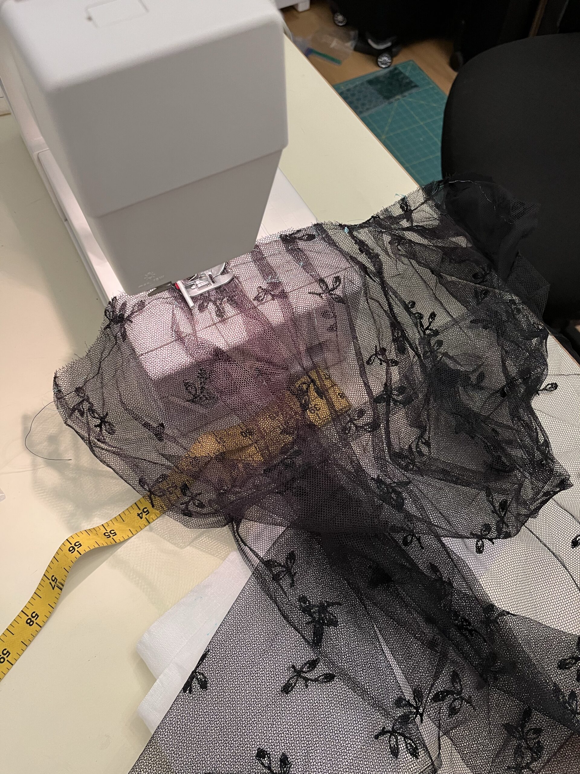 close-up view of a hood being sewn to a mantlet body