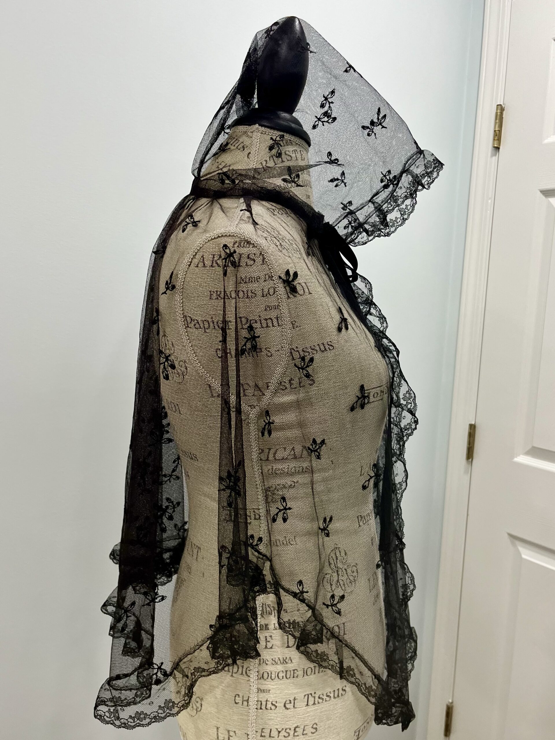 Profile view of black lace mantelet