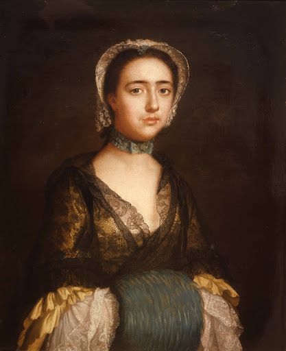 Half view of a slender young woman wearing a yellow sack back gown, a white cap and a black lace mantelet