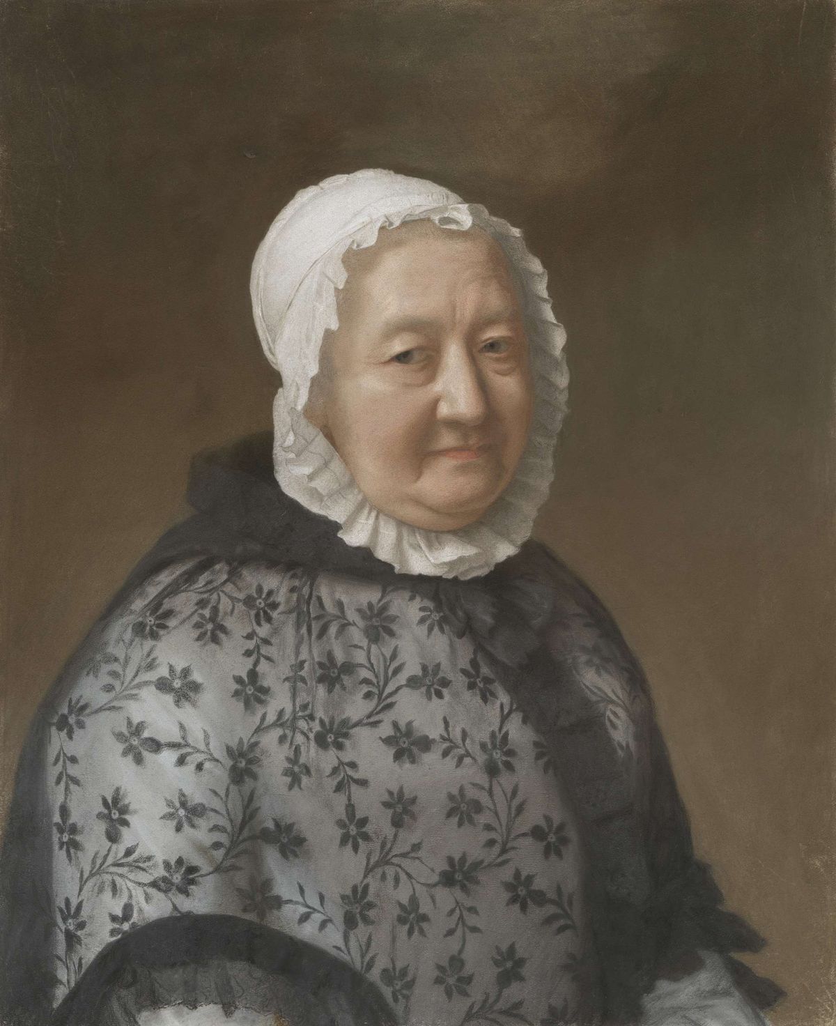 Half view of a plump elderly woman wearing a white lappet cap and a black lace cloak