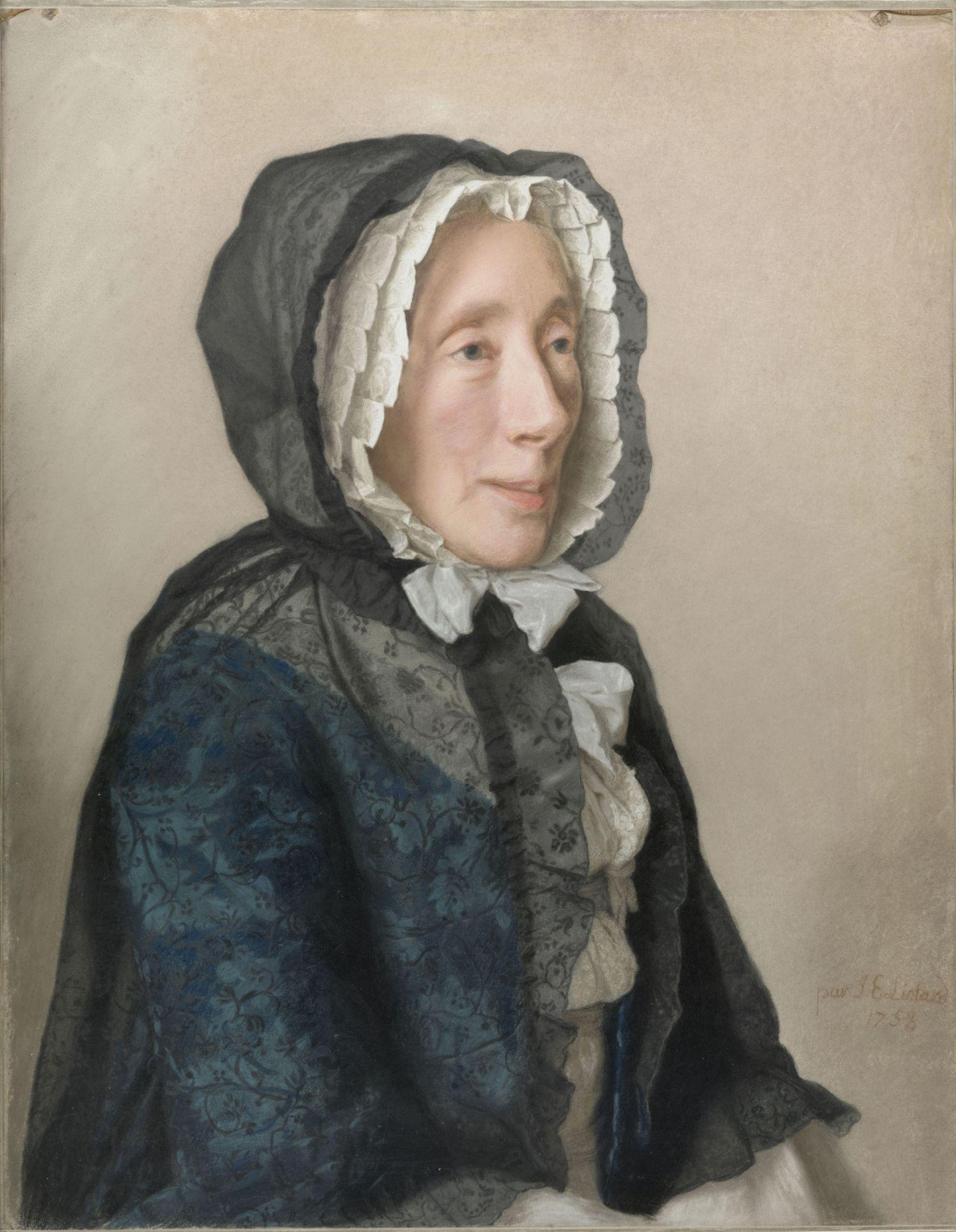 A woman sits in profile to the viewer. she is wearing a large black lace mantelet. The hood is up over her head.