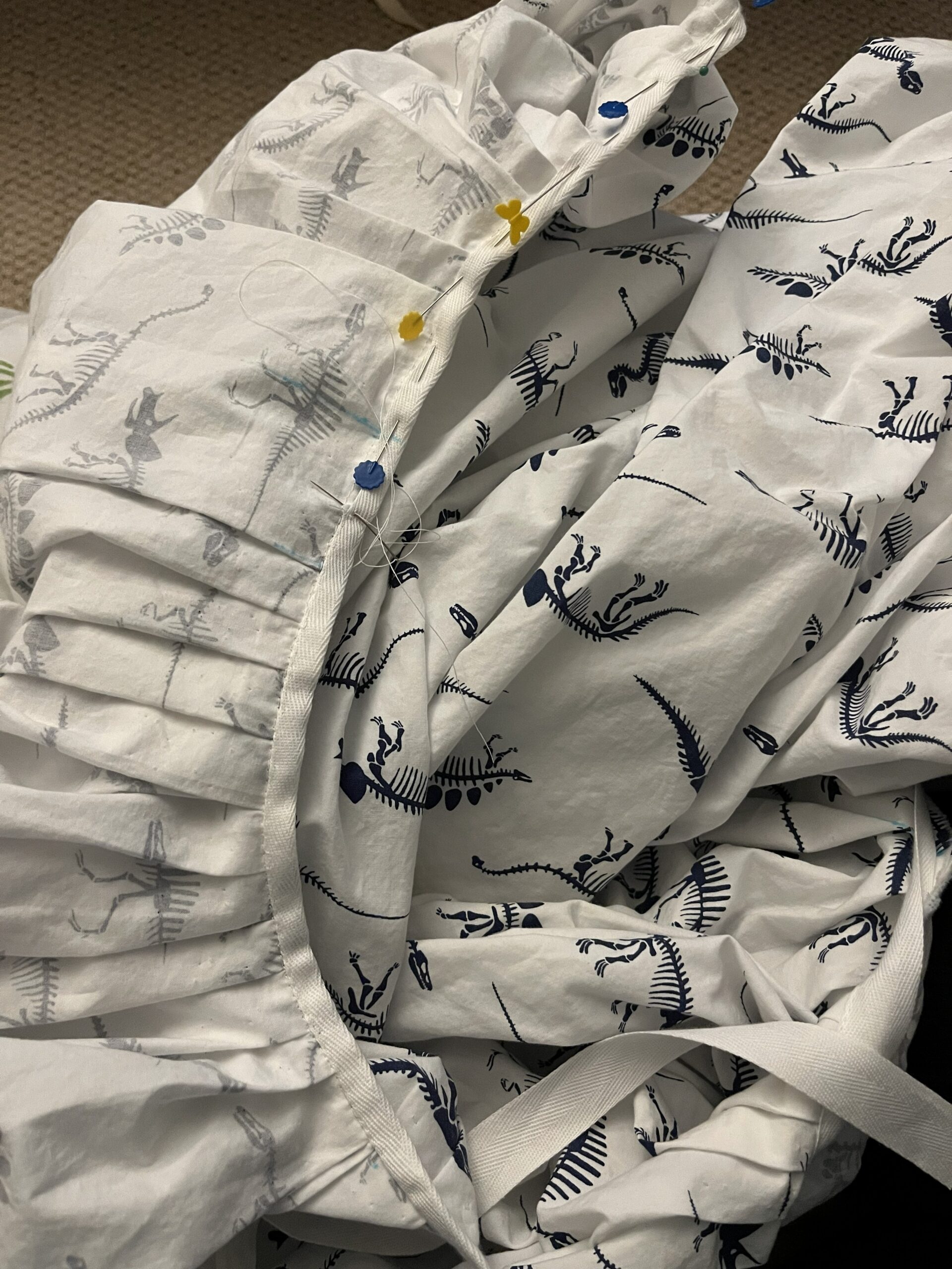 a waist tape being whipped down to the inside of an 18th century petticoat