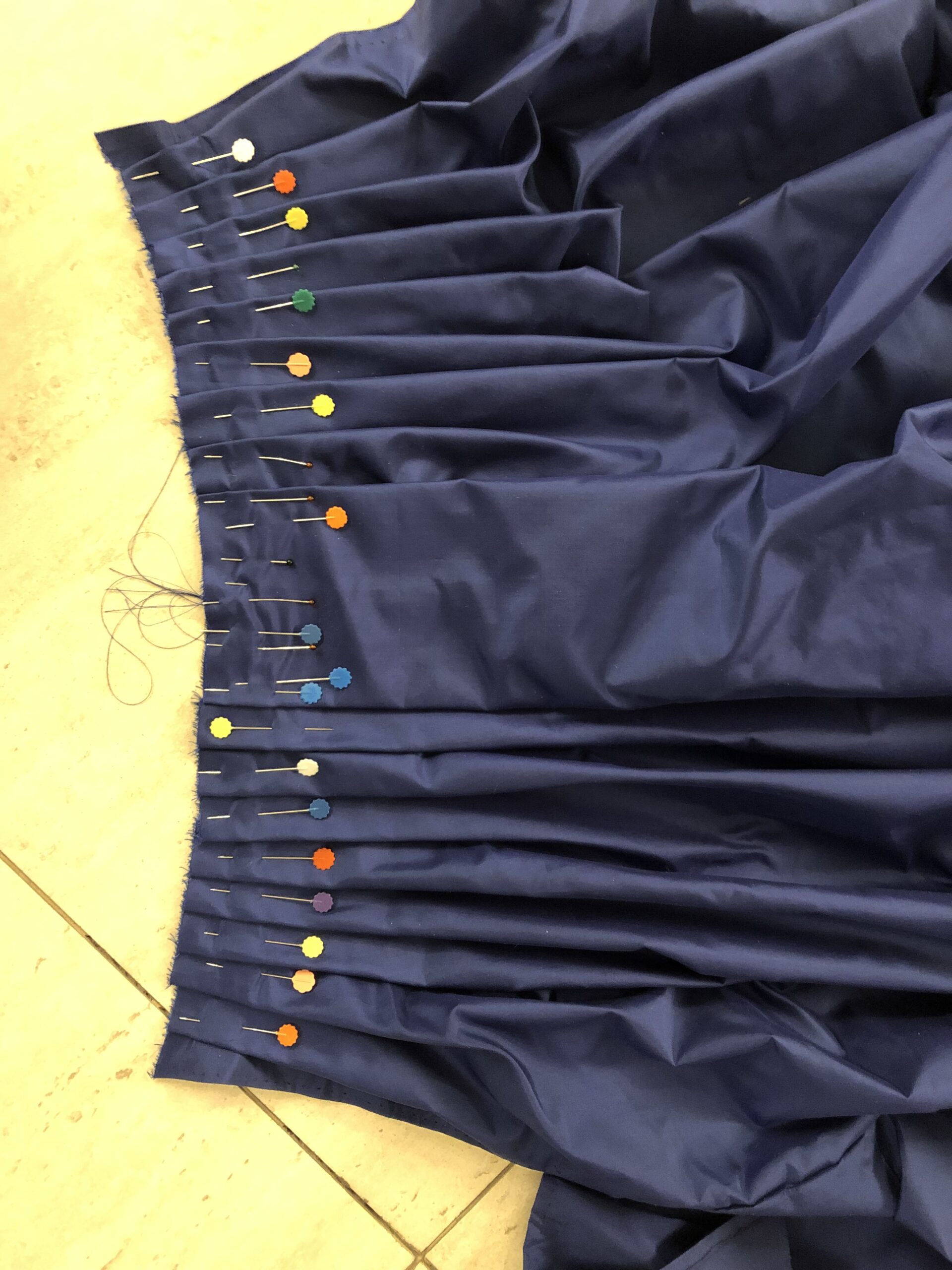 the pleated front panel of a blue wool 18th century petticoat