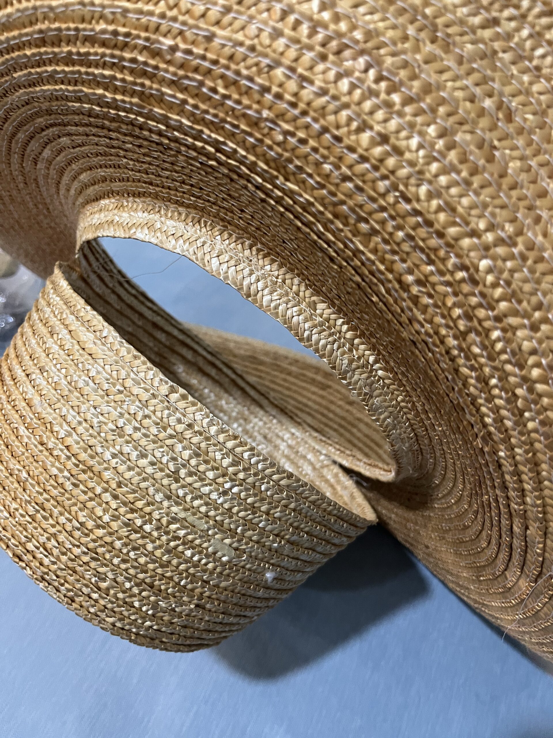 straw hat with the brim half-detached from the crown