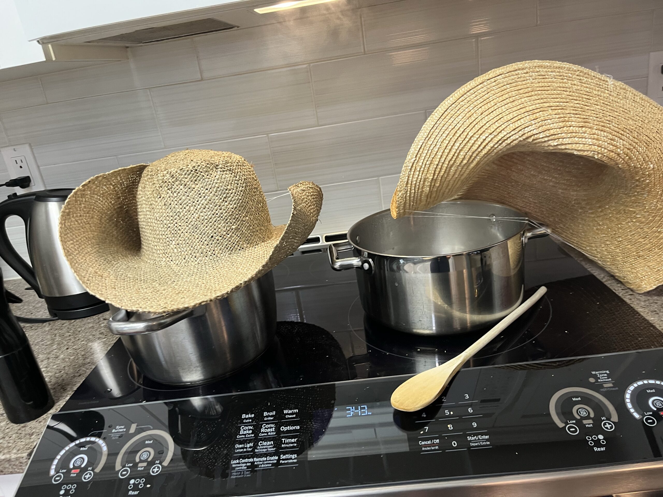 two hat blanks steaming over pots on a stove