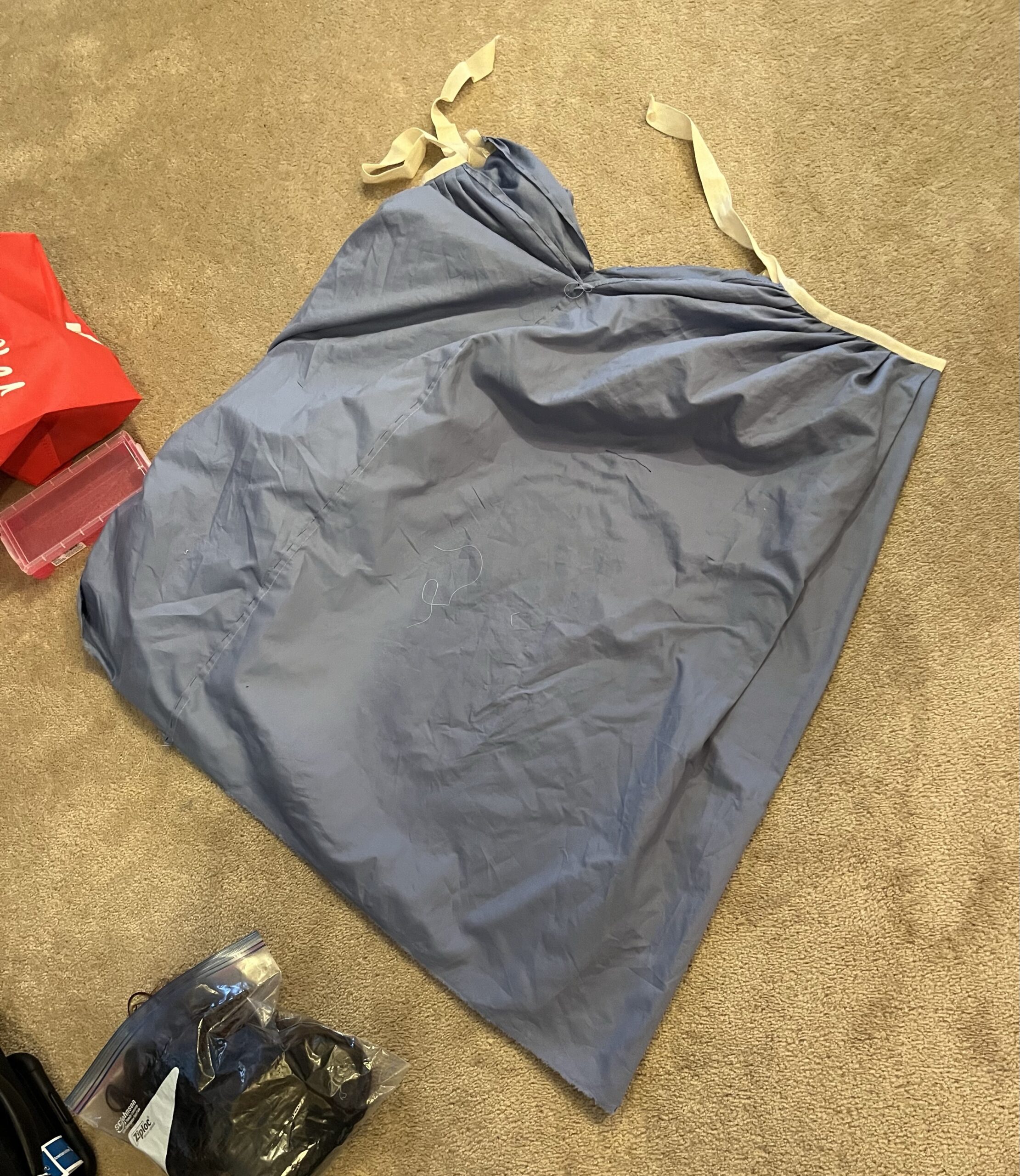 An 18th century petticoat made of blue cotton with white waist ties