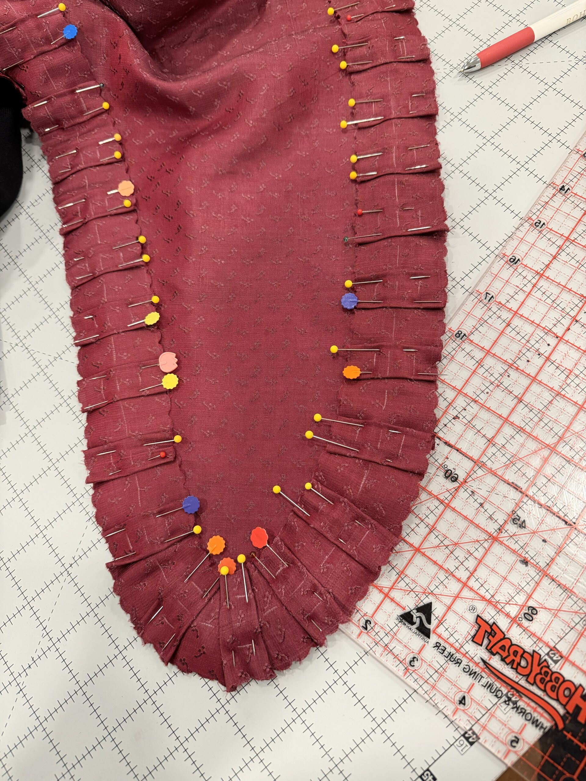 pinked pleats pinned to the front of the scroop charlotte mantle