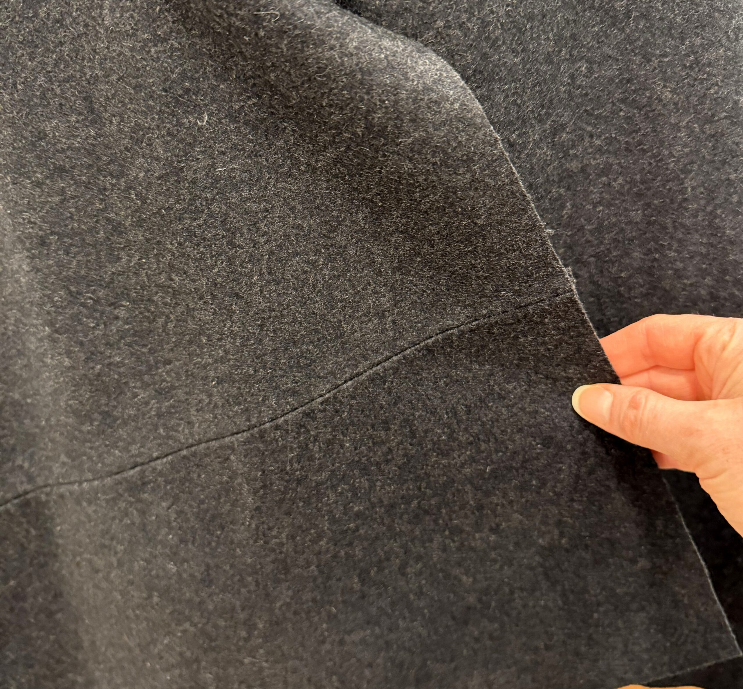 close-up of a finished seam in grey wool