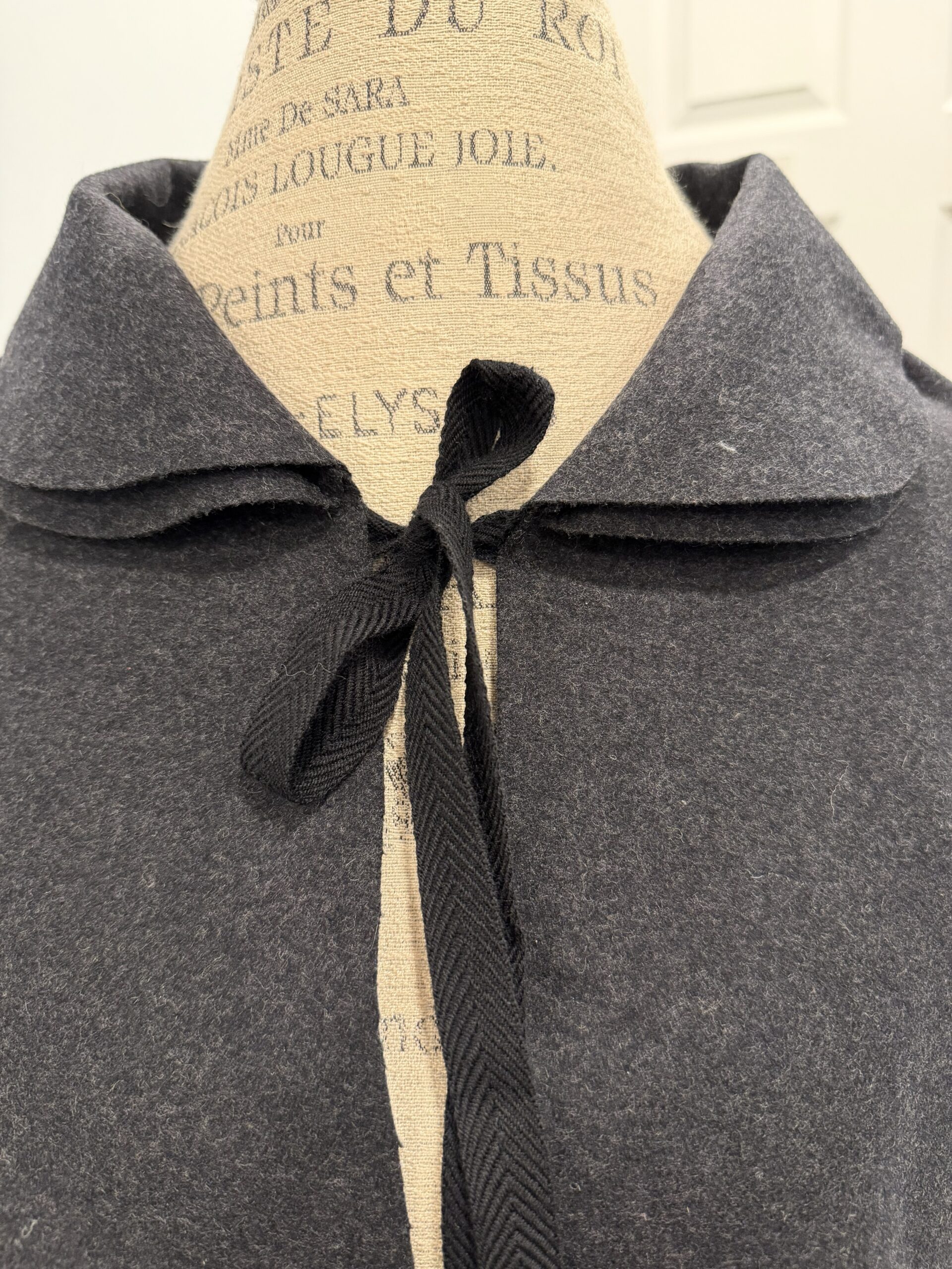 close-up view of black twill tape tied in a bow