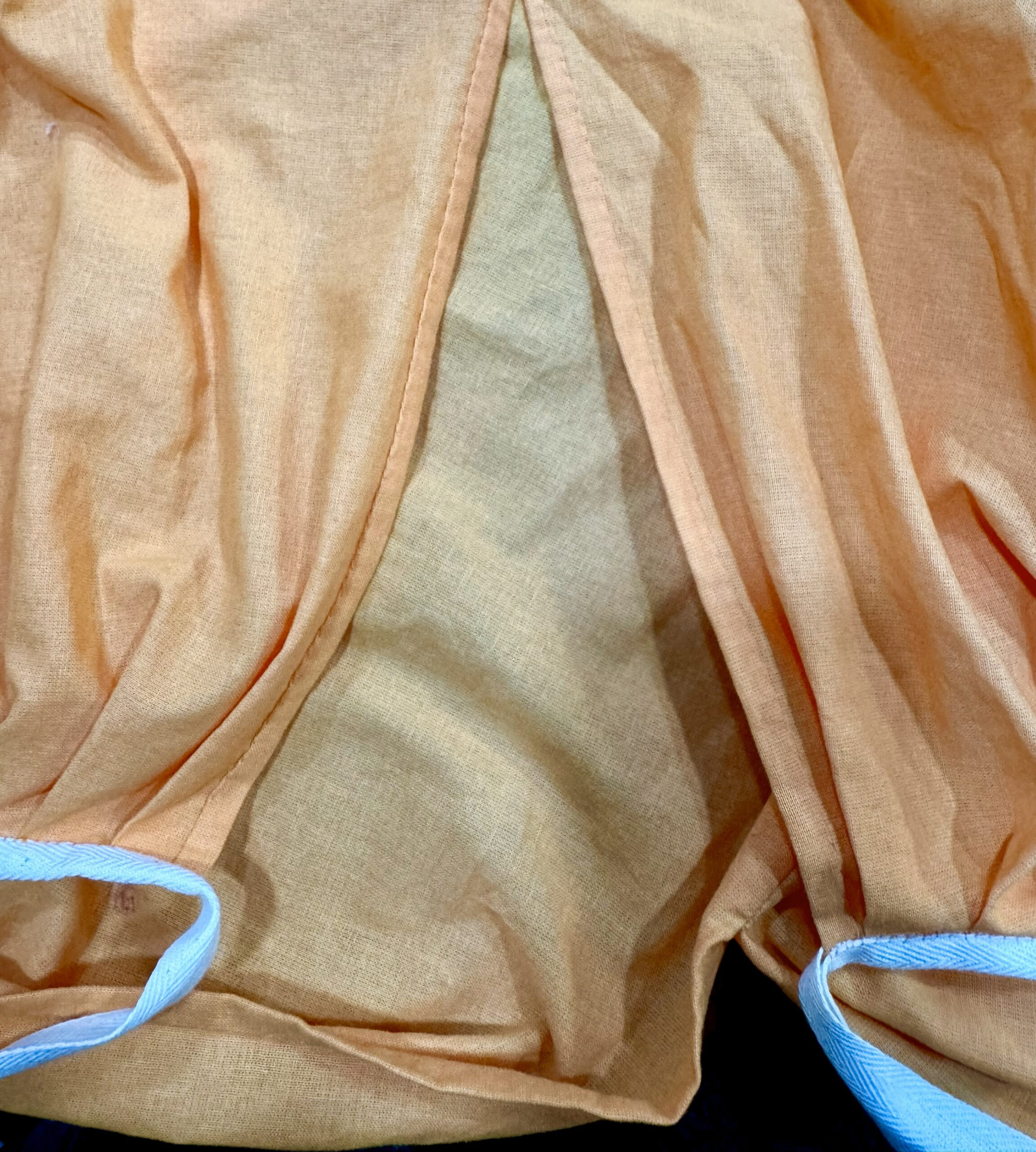 The hemmed edges of the pocket slit on an 18th century petticoat