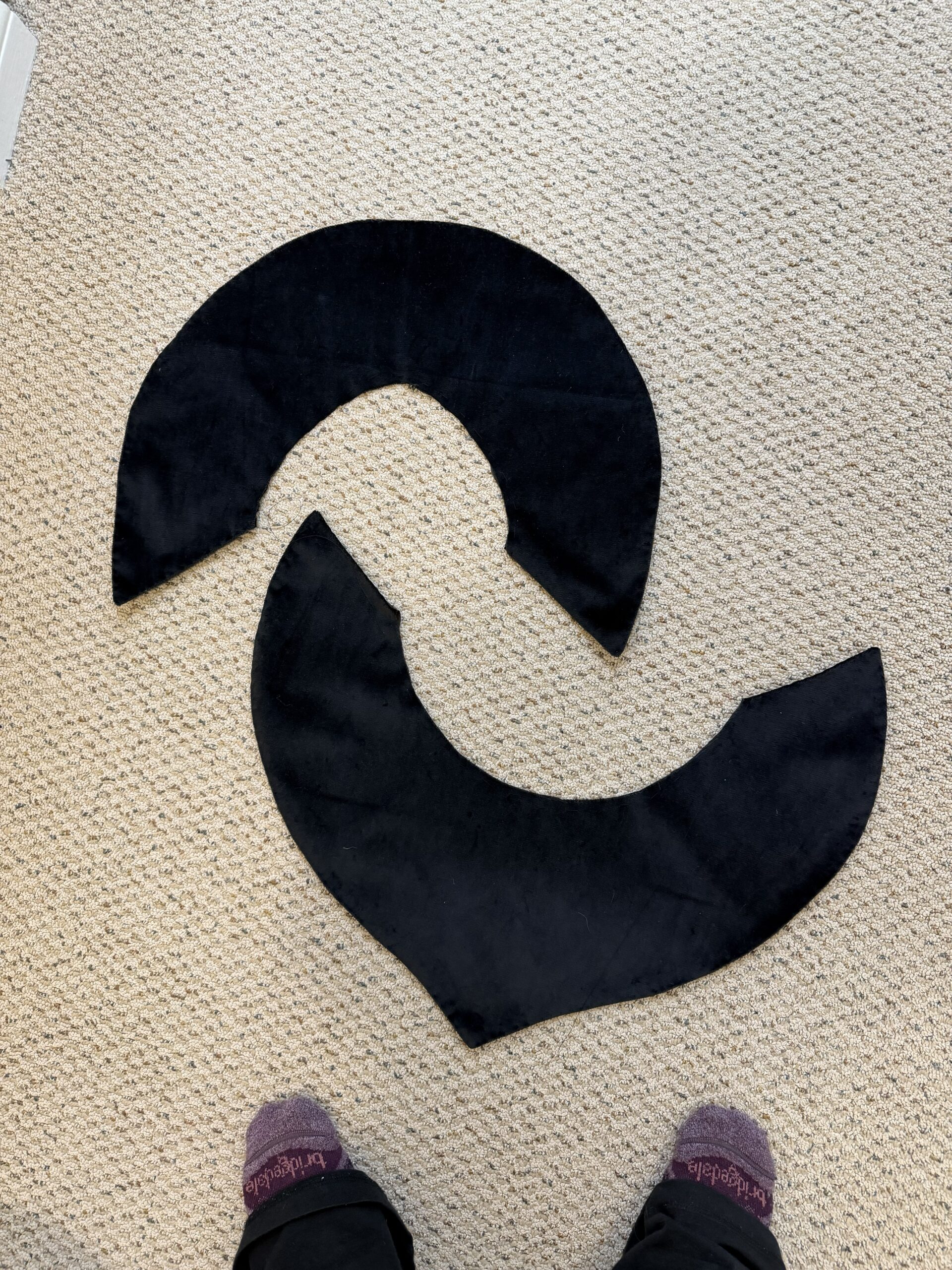 two black velvet crescent shaped hood capes