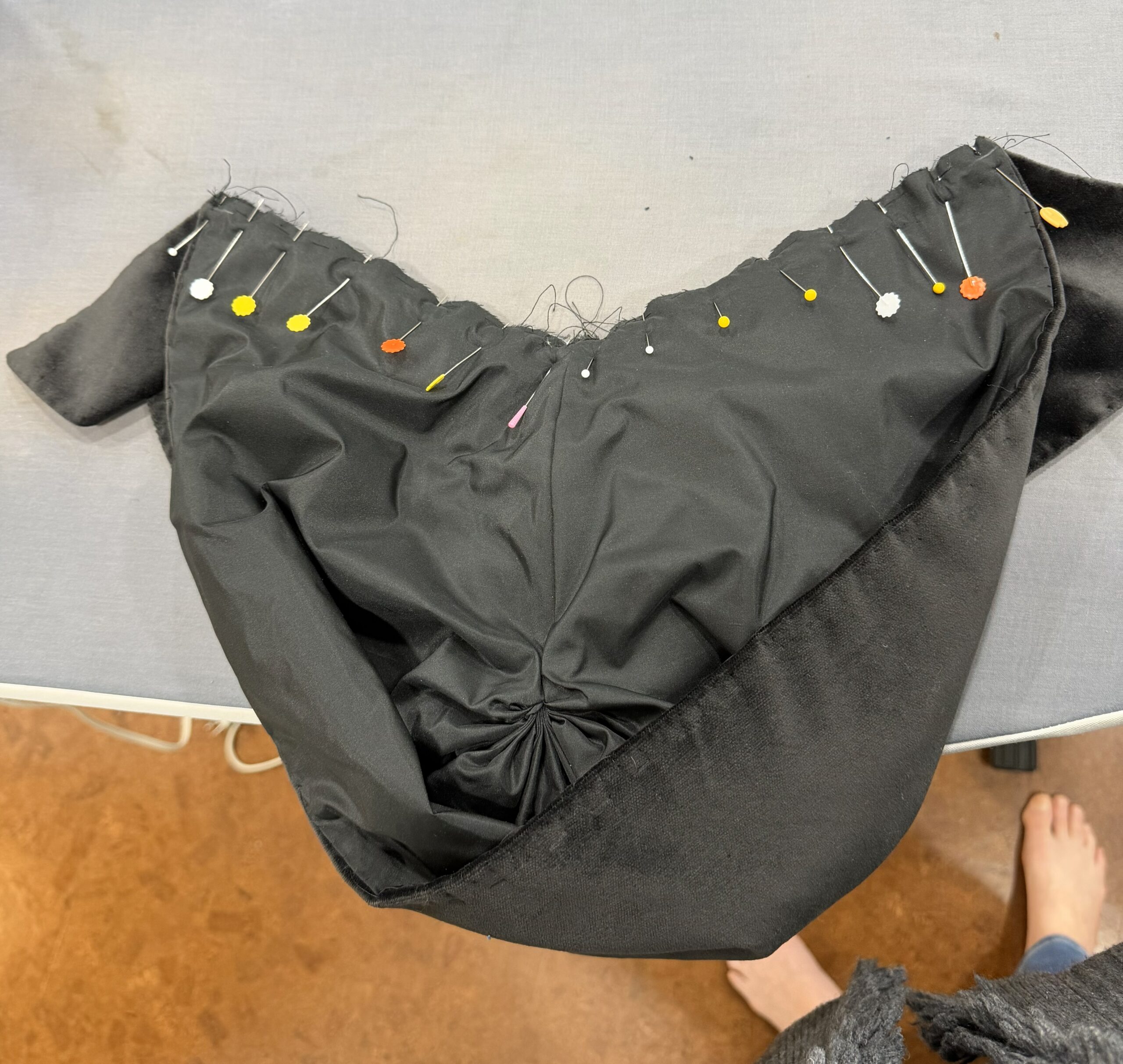 hood body pinned to cape