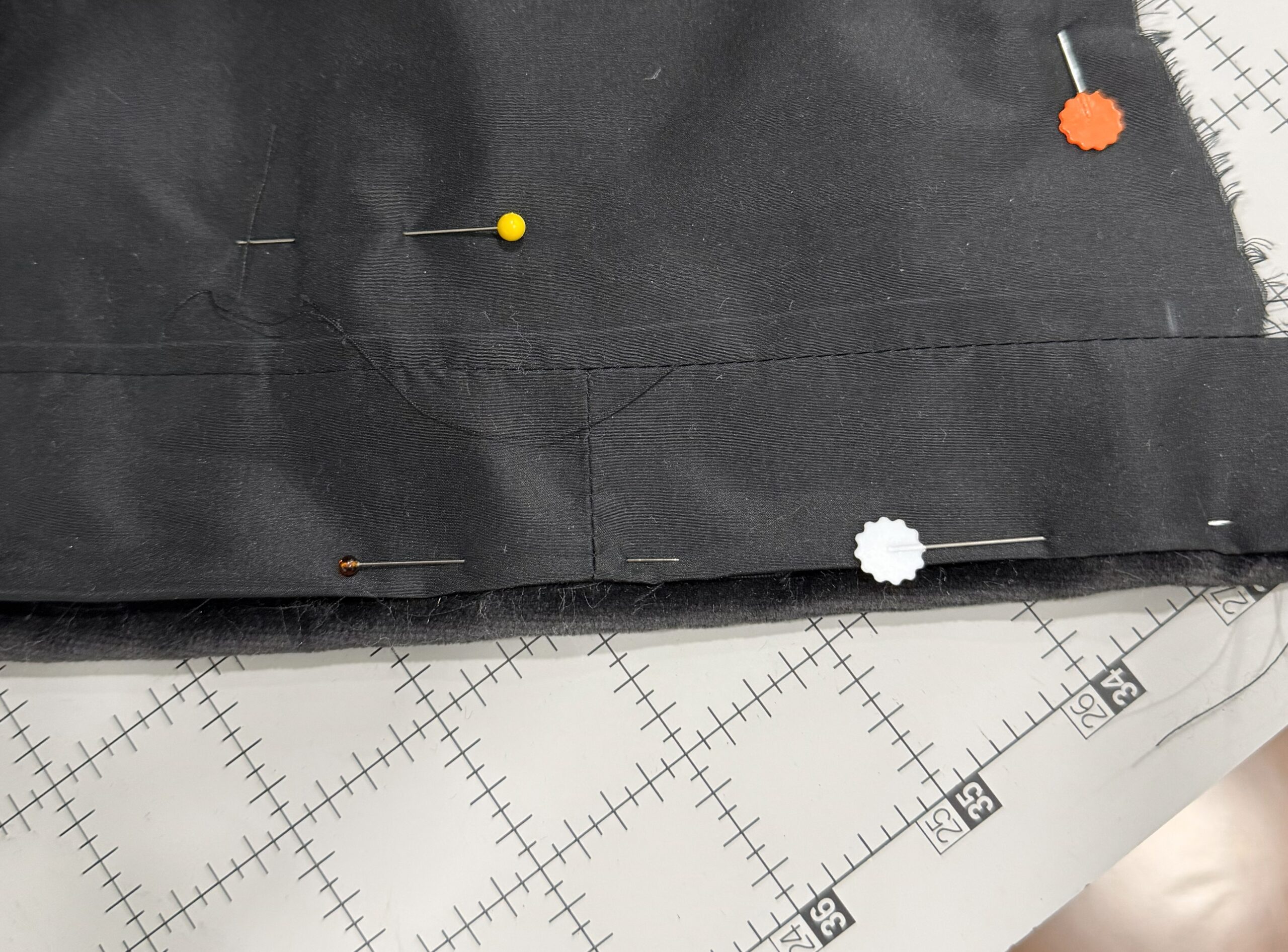 close up of lining pinned to hood body, showing turned in edge