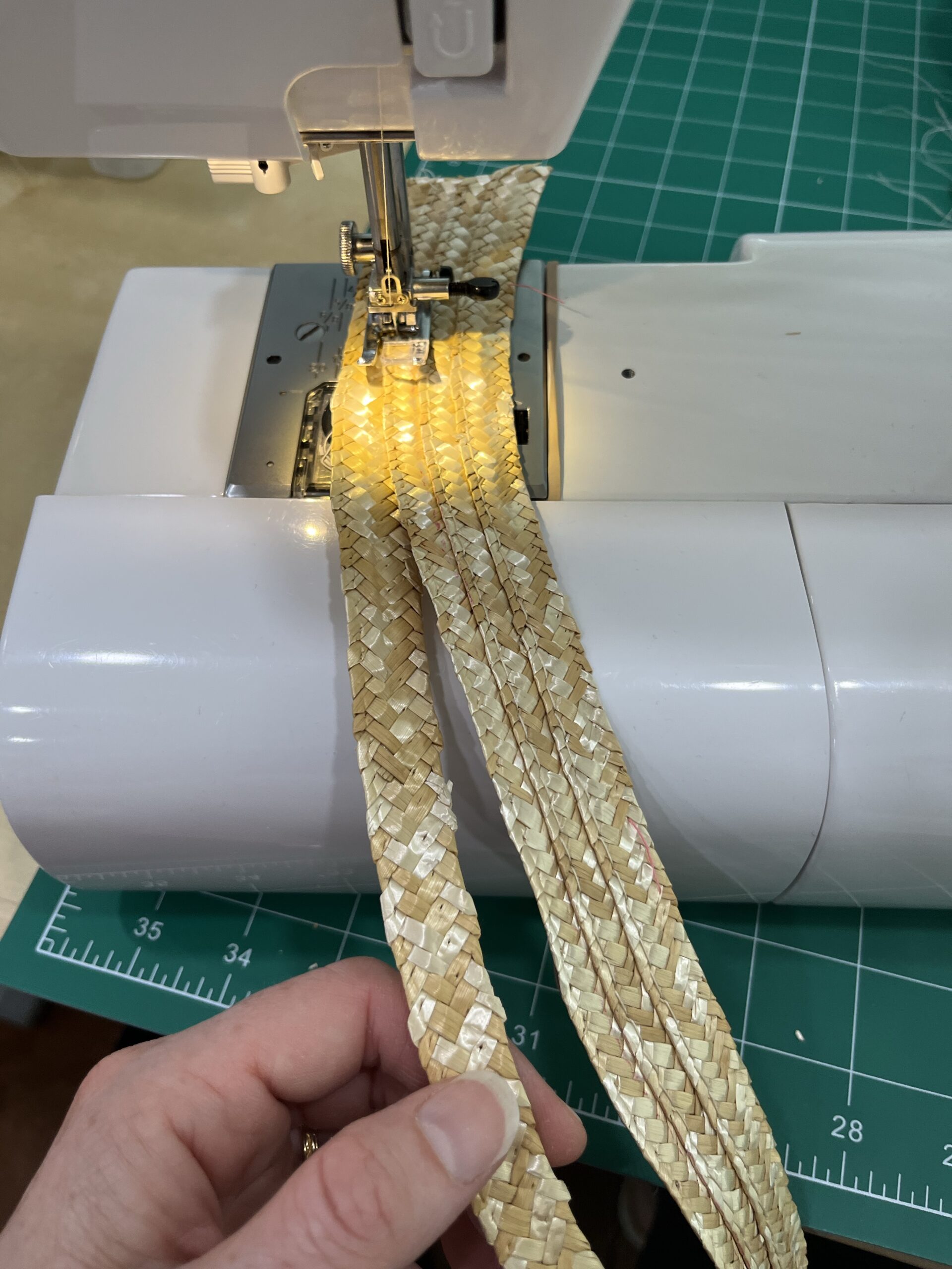 three rows of straw braid being sewn together