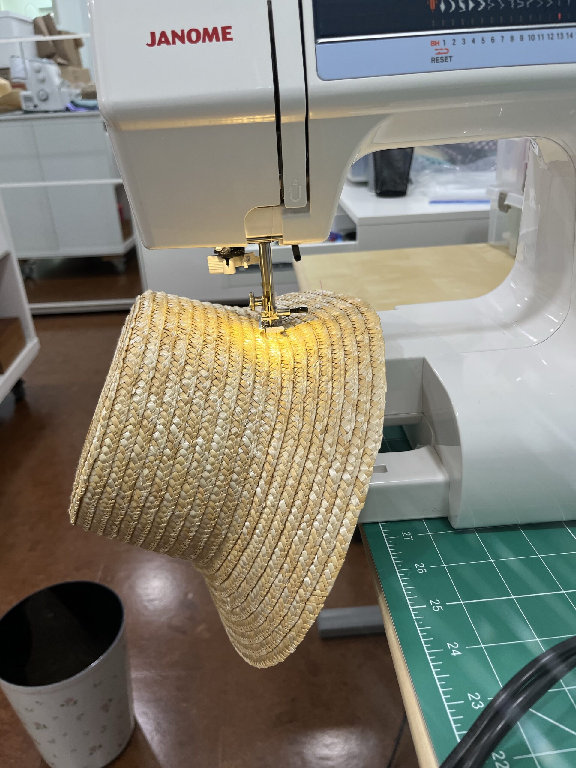 a straw hat being stitched on a sewing machine