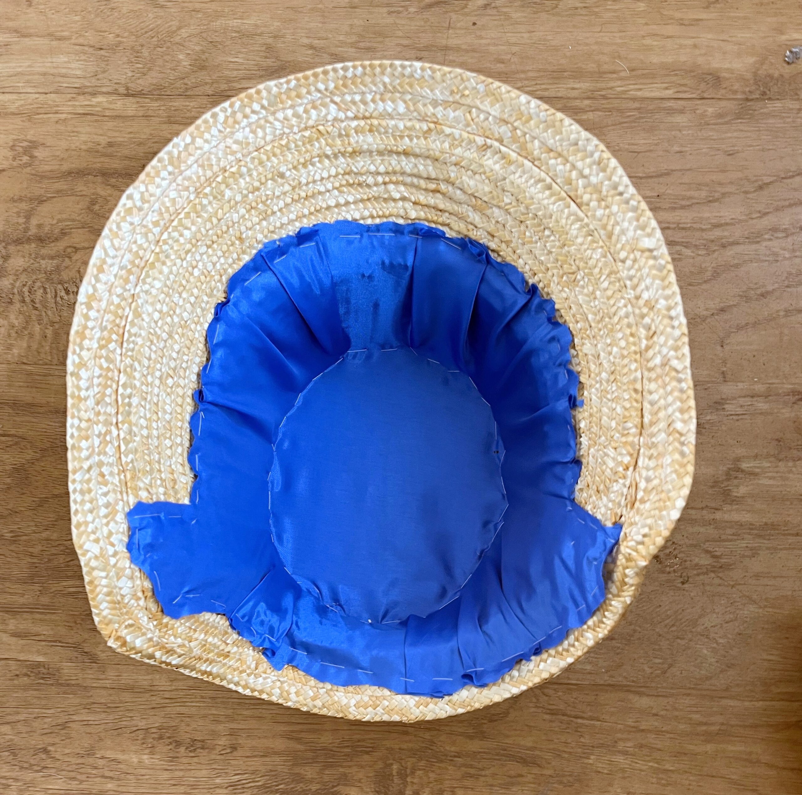 blue bemsilk lining stitched into a straw bonnet and trimmed