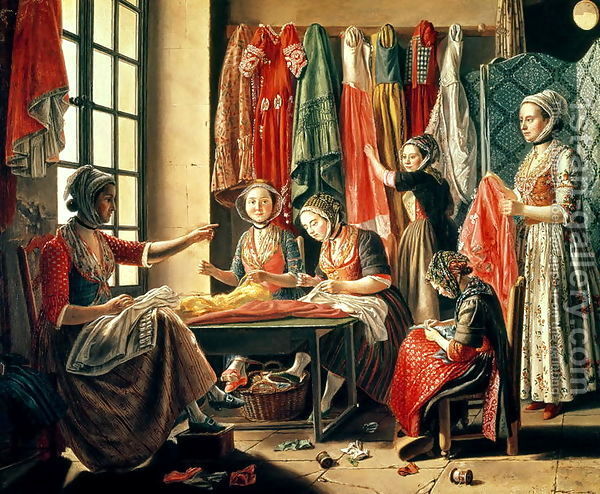 A group of women in bright colored print clothing sit at a table before a window hand sewing a bright colored piece of clothing
