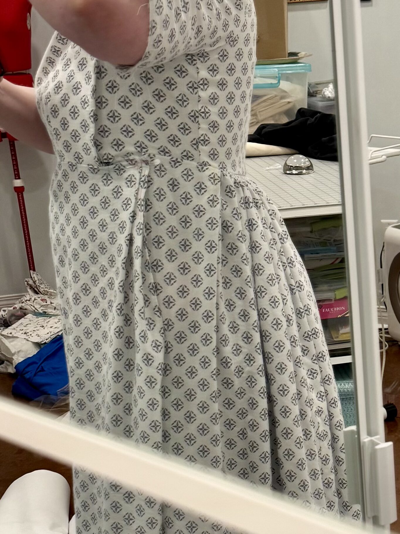 A side view of a regency bib front gown that accidentally dips really really low at the back