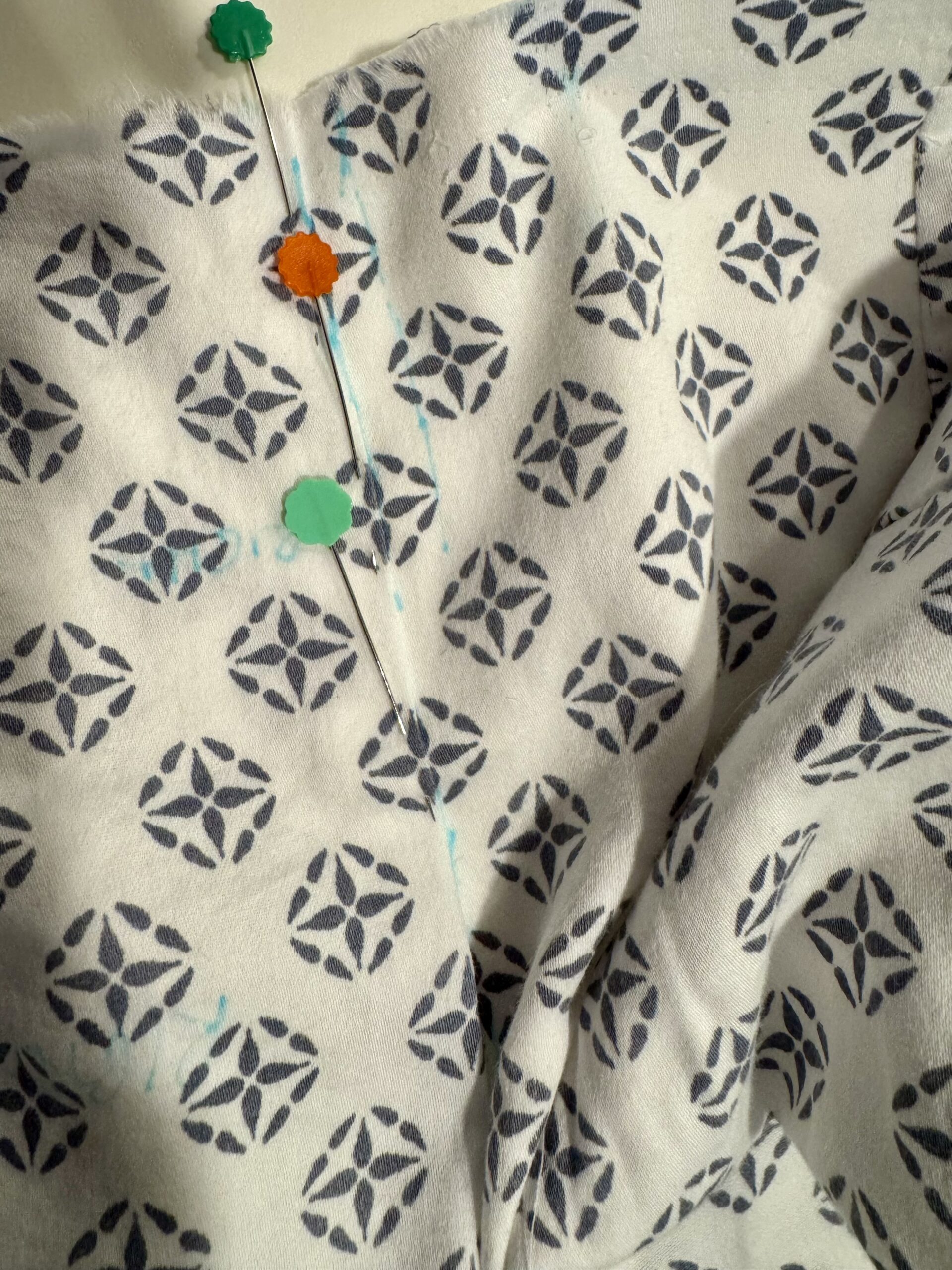 close up of block printed cotton being pattern matched between panels
